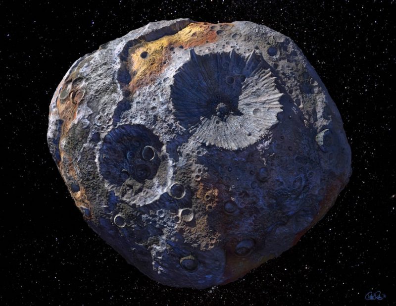 A roundish rocky body with 2 large and many small craters, with black background.