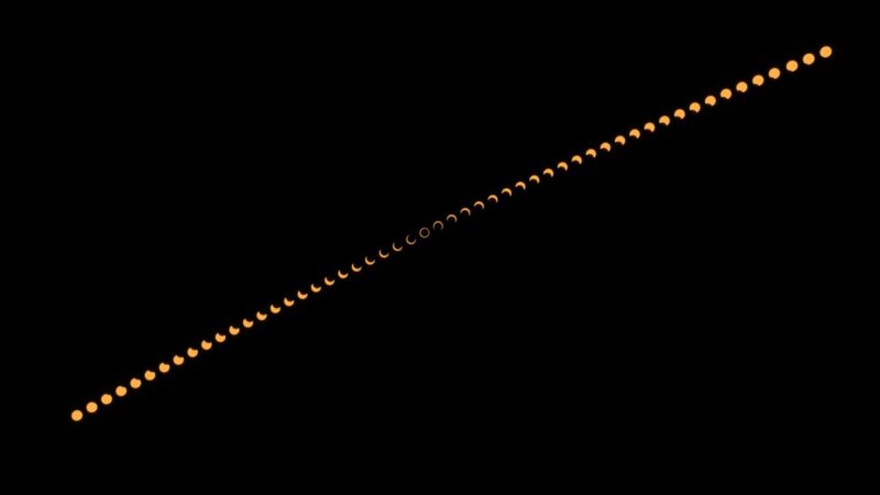 solar eclipse photos: A multitude of yellow solar eclipse images along the diagonal.