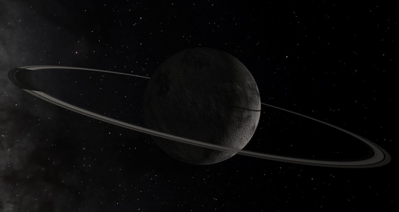 Chiron: Rocky planet-like body with 2 thin rings around it and stars in background.