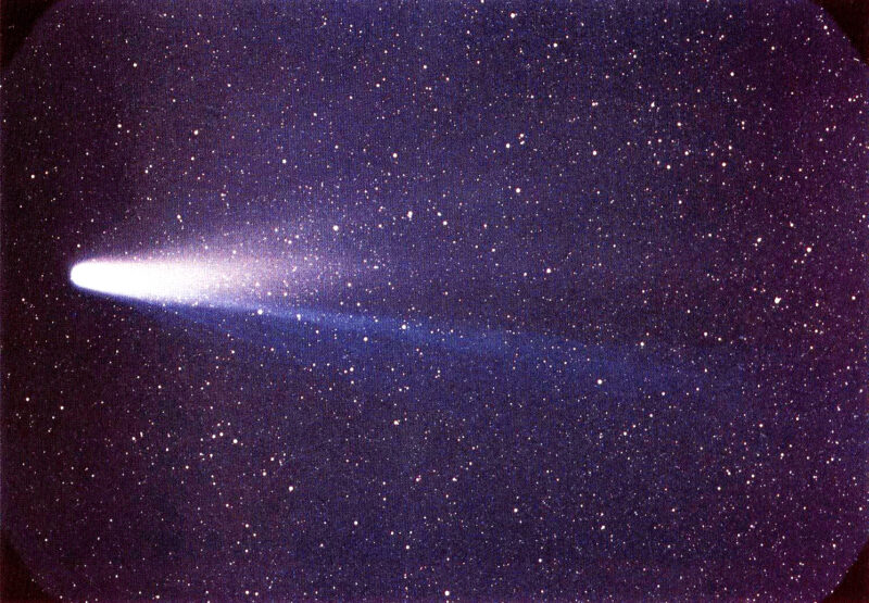 Comet Halley: Starfield, with a large bright comet with lavender and blue tails streaking out to the right.