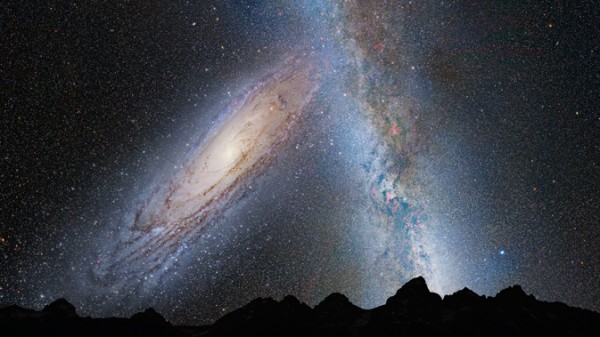 Night sky with huge, bright oblique swirl of stars - Andromeda galaxy - next to cloudy band of Milky Way.