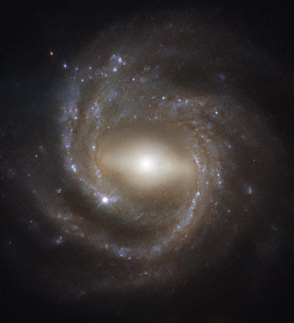 Horizontally stretched out glowing bulge - like a bar - with spiral arms around it. 