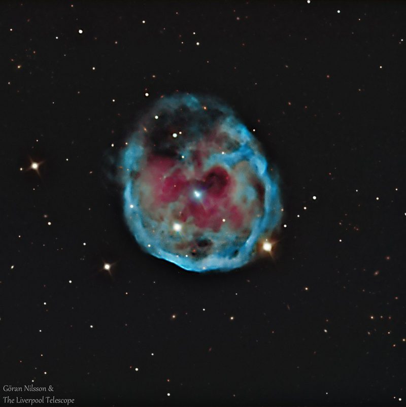 Electric blue ring with reddish interior and central bluish star.