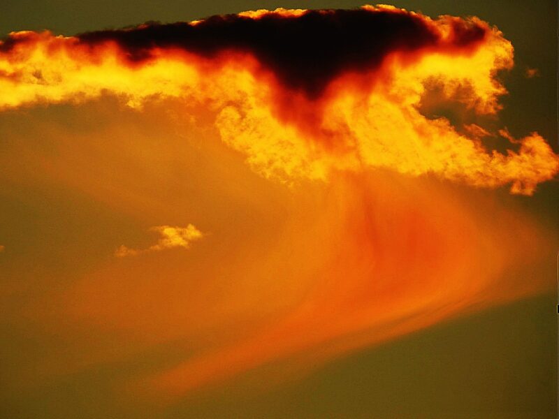 Black and orange clouds with curving orangish and redish mist below them.