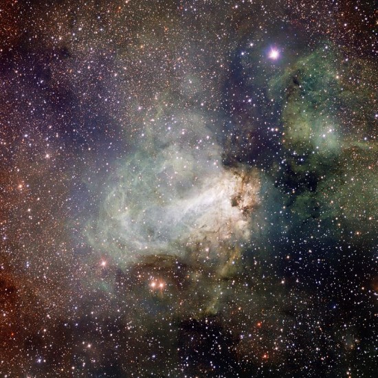 Very dense star field with white, C shaped nebula with a lighter bar across the middle.